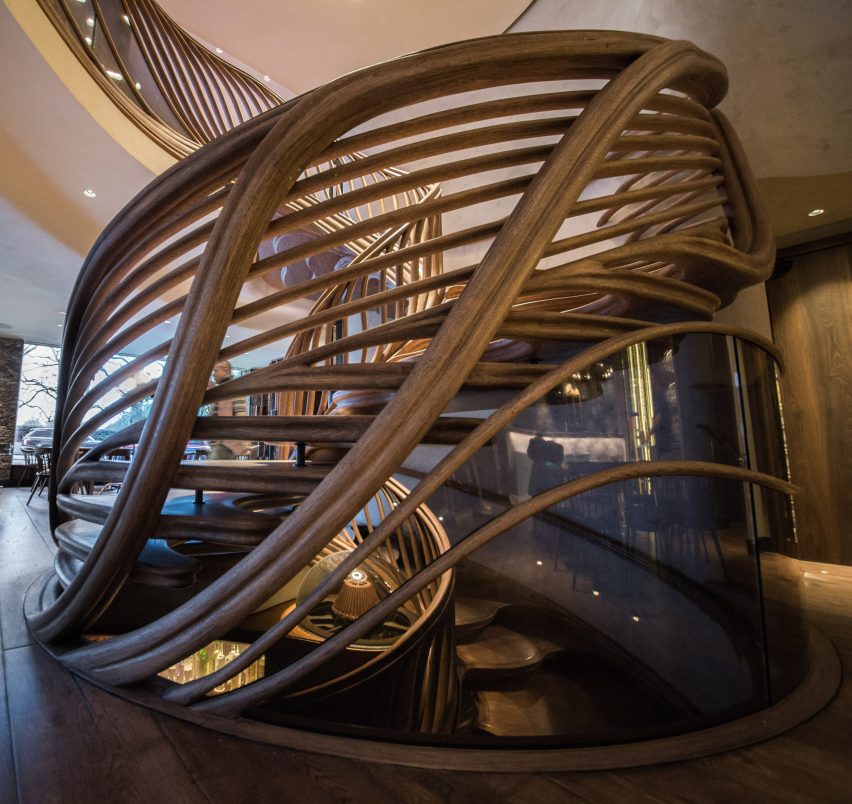 Atmos Studio's spiralling timber staircase features "leaf-like" stairs that emerge from a structural stem