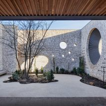 Porthole openings connect community centre and kindergarten in Cambridge