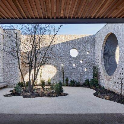Porthole openings connect community centre and kindergarten in Cambridge