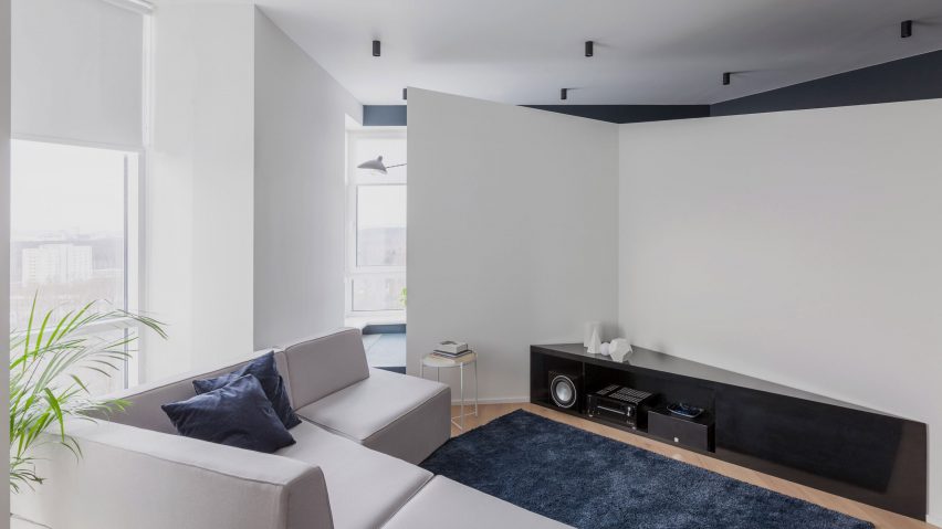 Asymmetrical walls divide up blue and white apartment in Moscow