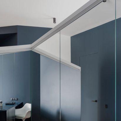 Asymmetrical walls divide up blue and white apartment in Moscow