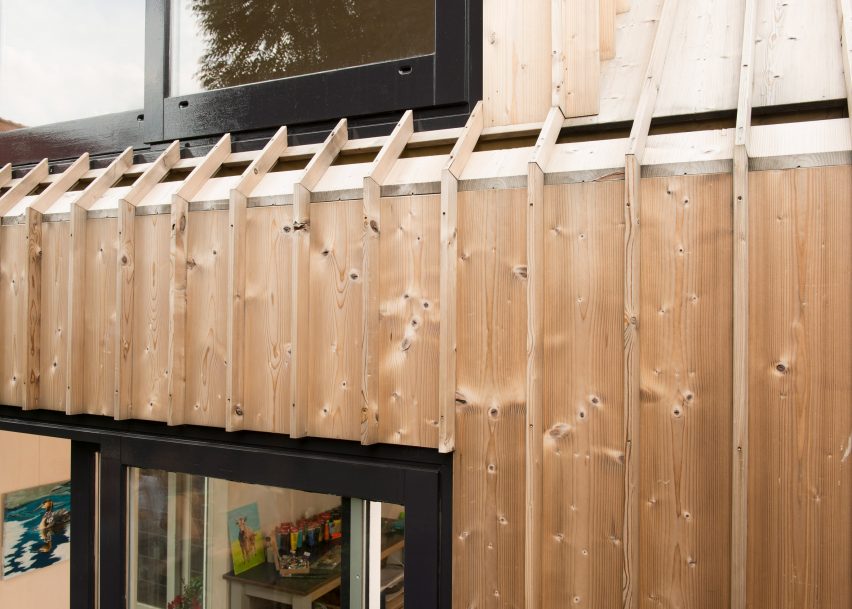 Timber-clad painting studio by Open Kaart wraps around and old brick shed