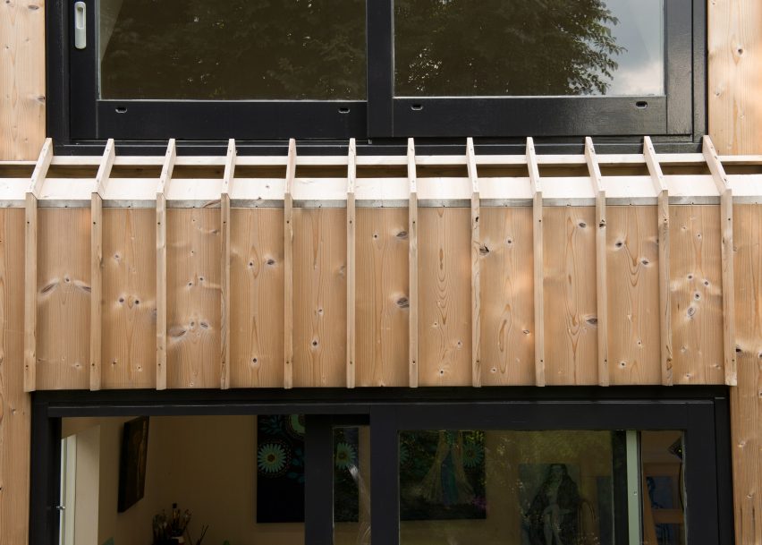 Timber-clad painting studio by Open Kaart wraps around and old brick shed