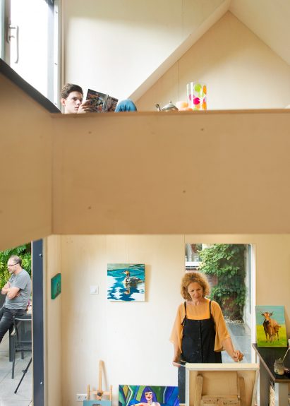 Timber-clad painting studio by Open Kaart wraps around and old brick shed