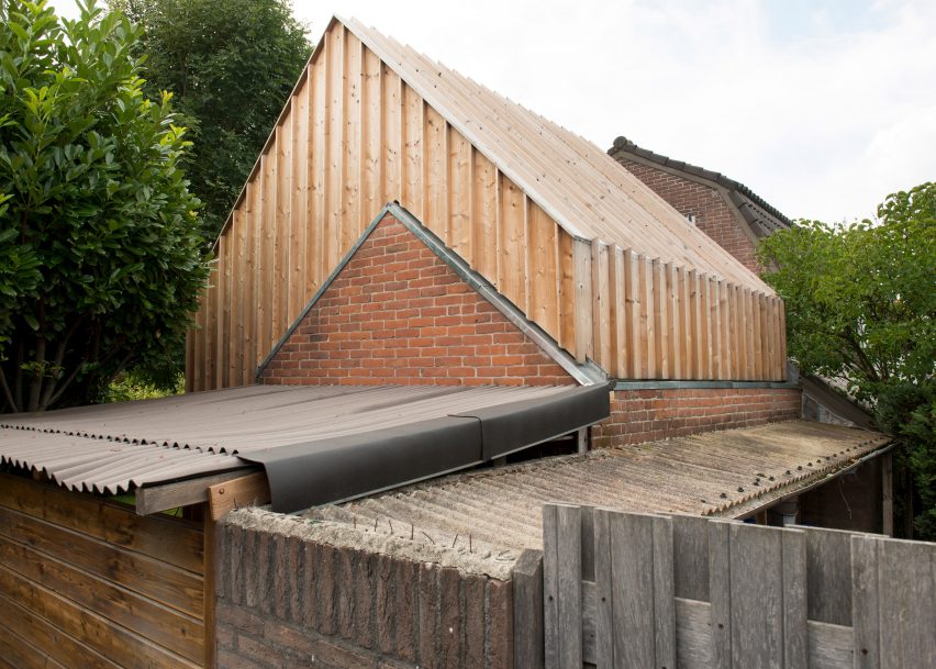 Timber-clad painting studio by Open Kaart wraps around and old brick shed