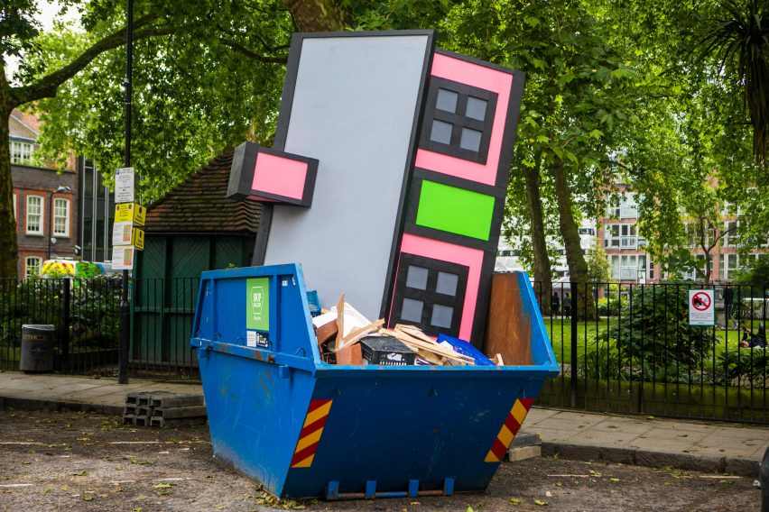 Richard Woods dumps one of his cartoon houses in a London skip
