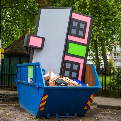 Richard Woods dumps one of his cartoon houses in a London skip