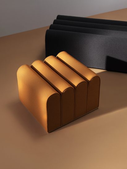 Note Design Studio creates architecture-inspired poufs called Arkad, designed to look like architectural arches.