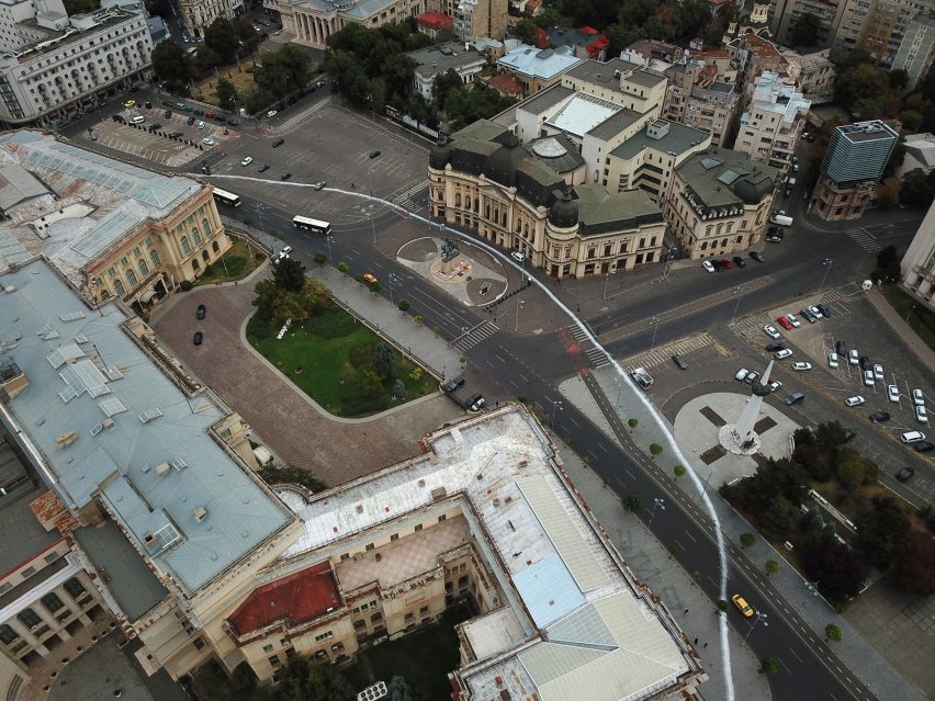 Artist paints impermanent white circle around the Romanian National Museum of Art