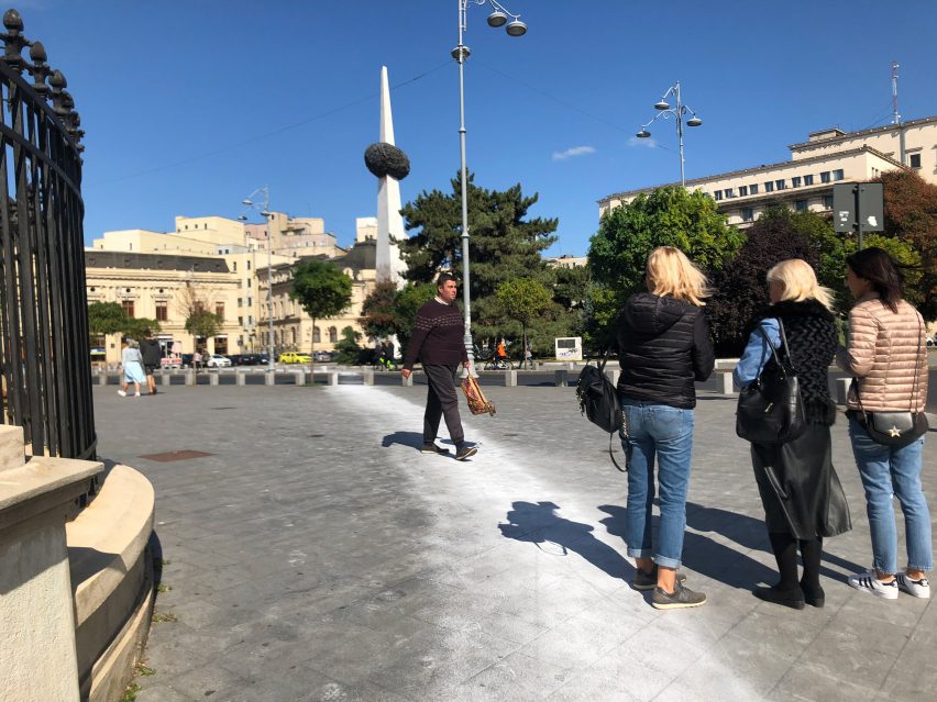 Artist paints impermanent white circle around the Romanian National Museum of Art