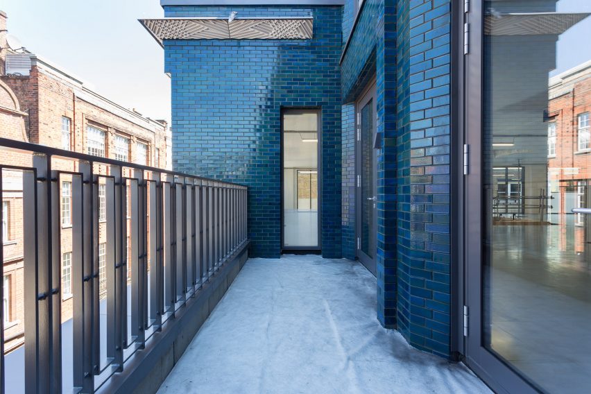 Iridescent turquoise tiles cover Damien Hirst's new flagship studio by Stiff + Trevillion