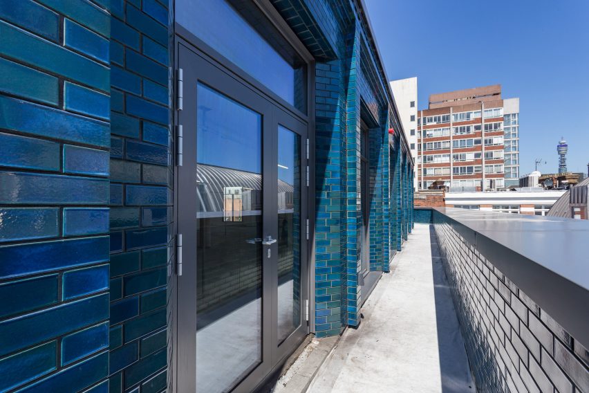 Iridescent turquoise tiles cover Damien Hirst's new flagship studio by Stiff + Trevillion