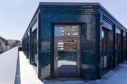 Iridescent turquoise tiles cover Damien Hirst's new flagship studio by Stiff + Trevillion