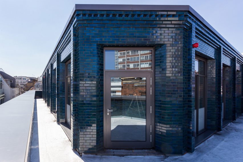 Iridescent turquoise tiles cover Damien Hirst's new flagship studio by Stiff + Trevillion