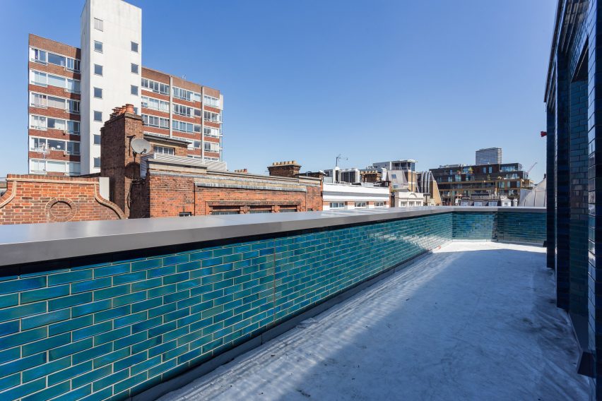 Iridescent turquoise tiles cover Damien Hirst's new flagship studio by Stiff + Trevillion