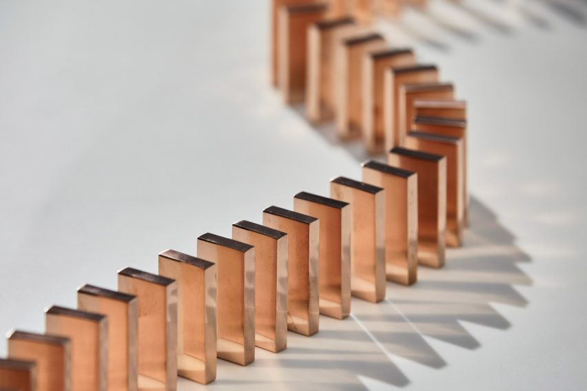 Glithero's interactive lamp is illuminated by a toppling row of dominoes