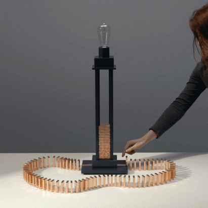 Glithero's interactive lamp is illuminated by a toppling row of dominoes
