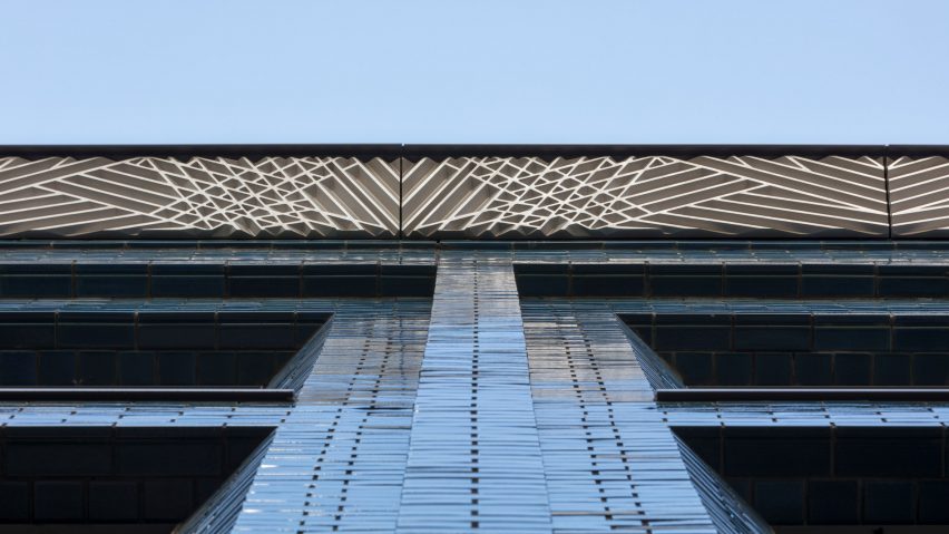 Iridescent turquoise bricks front Damien Hirst’s new studio by Stiff + Trevillion