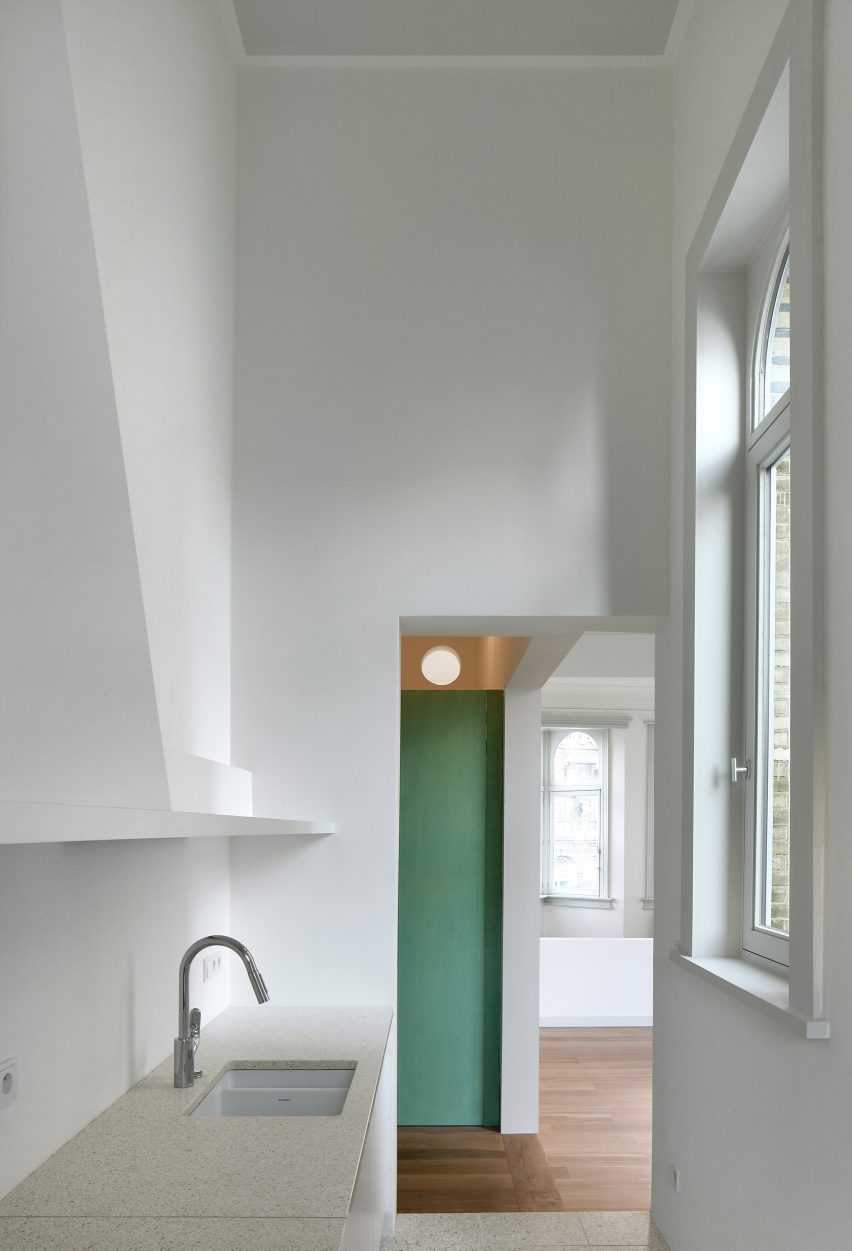 Bovenbouw transforms trio of historic buildings into unique apartments on Antwerp's busiest shopping street