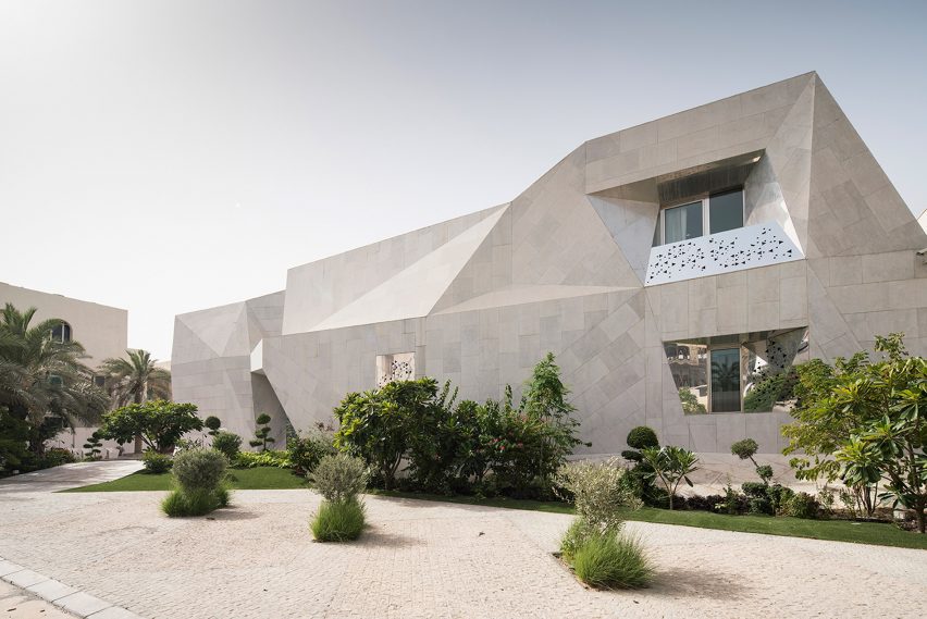 AGi Architects' Rock House features "origami-like" stone facades