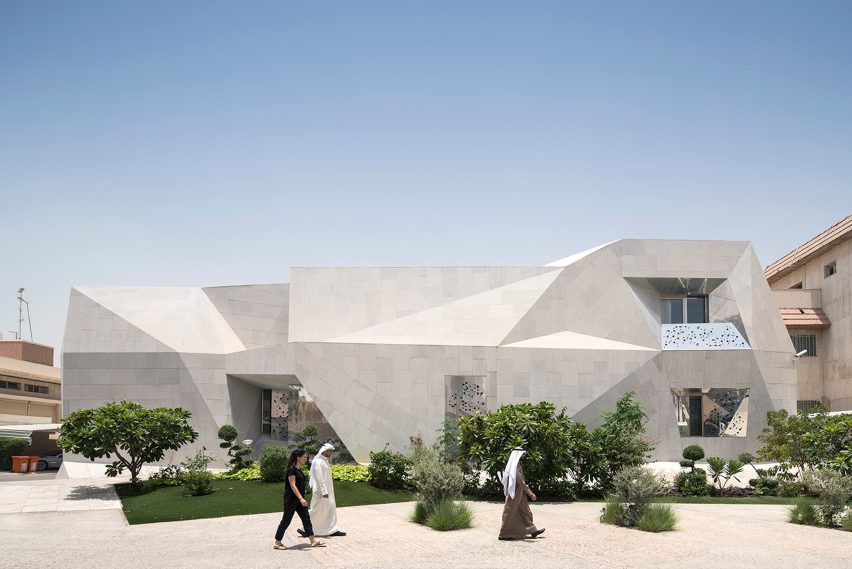 AGi Architects' Rock House features "origami-like" stone facades