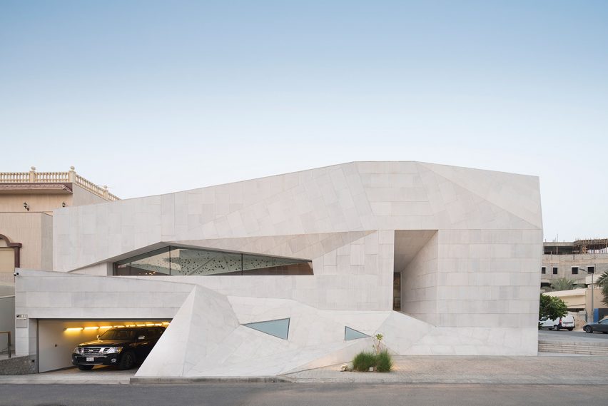 AGi Architects' Rock House features "origami-like" stone facades