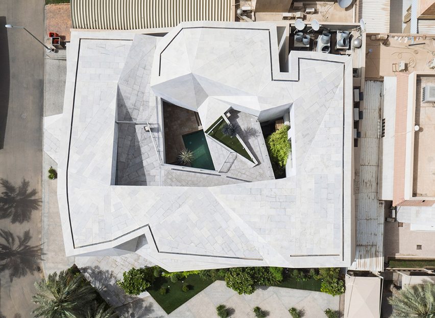 AGi Architects' Rock House features "origami-like" stone facades
