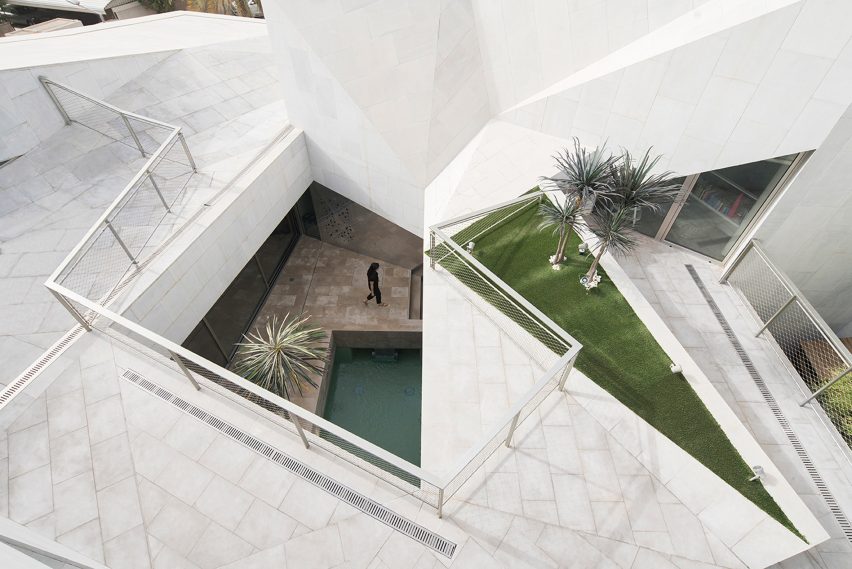AGi Architects' Rock House features "origami-like" stone facades