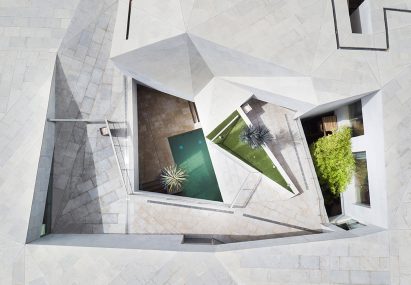 AGi Architects' Rock House features "origami-like" stone facades