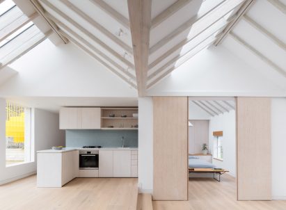 Kitchen and bedroom of Mile End Road apartment by Vine Architecture Studio