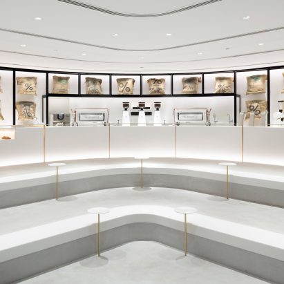 Nendo inserts stepped concrete platforms into Kuwait coffee shop
