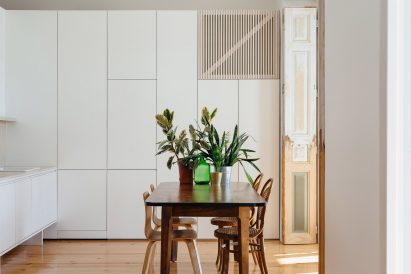 Mismatched chairs inside Apartment in Lapa's dining room by Filipe Fonseca Costa