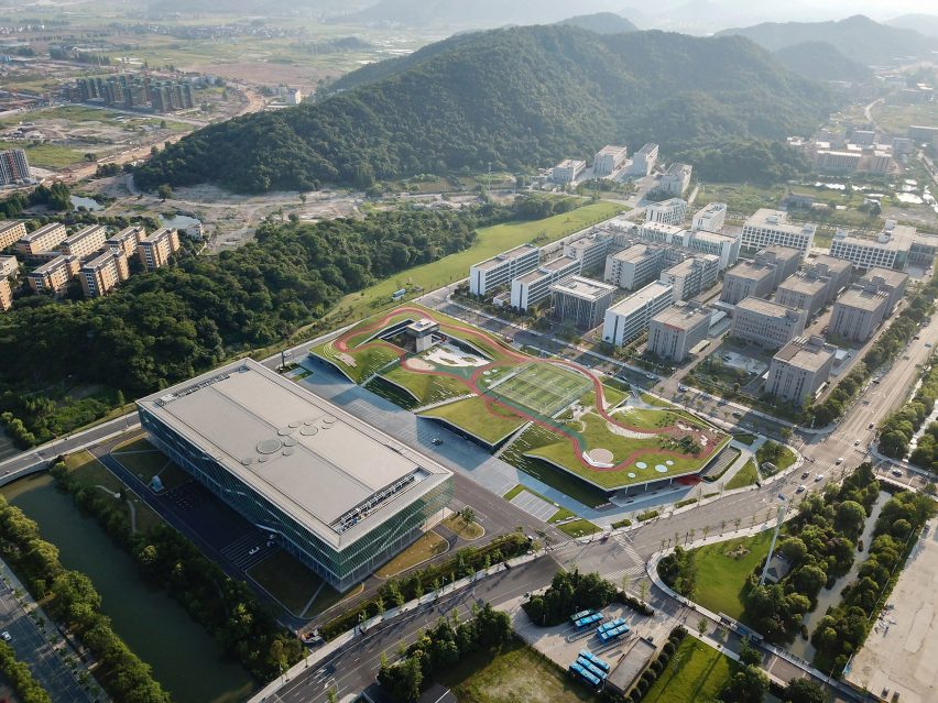Hangzhou Cloud Town Exhibition Center by Approach Design has a green roof with a running track