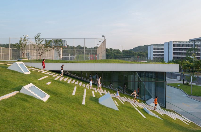 Hangzhou Cloud Town Exhibition Center by Approach Design has a green roof with a running track