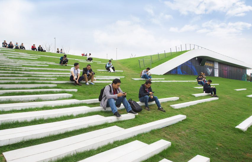 Hangzhou Cloud Town Exhibition Center by Approach Design has a green roof with a running track