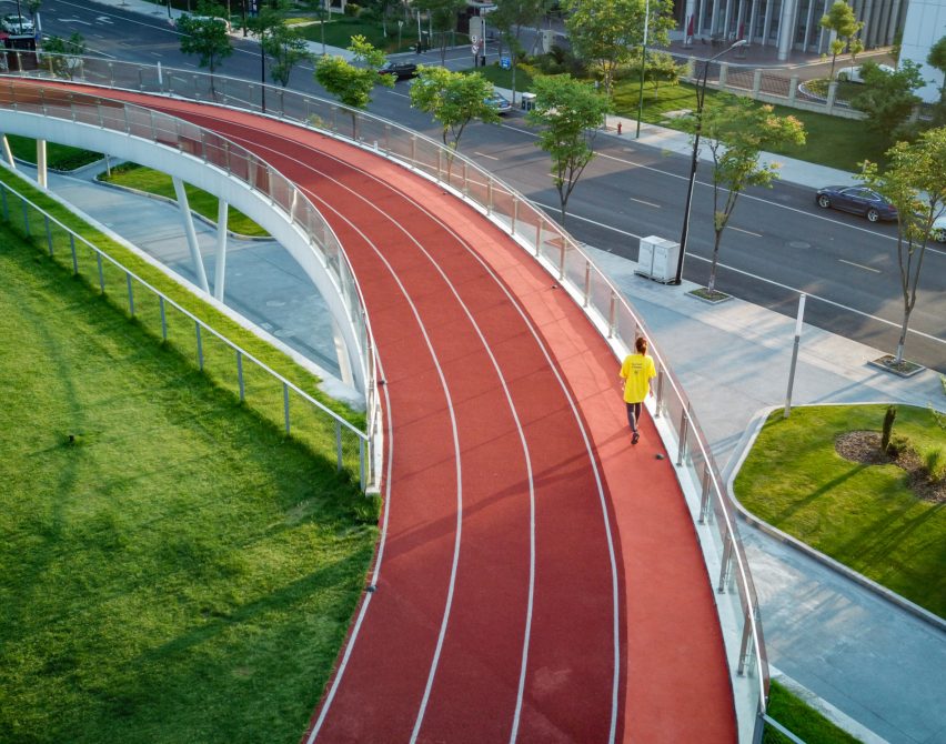 Hangzhou Cloud Town Exhibition Center by Approach Design has a green roof with a running track