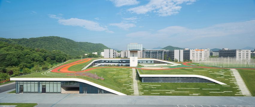 Hangzhou Cloud Town Exhibition Center by Approach Design has a green roof with a running track