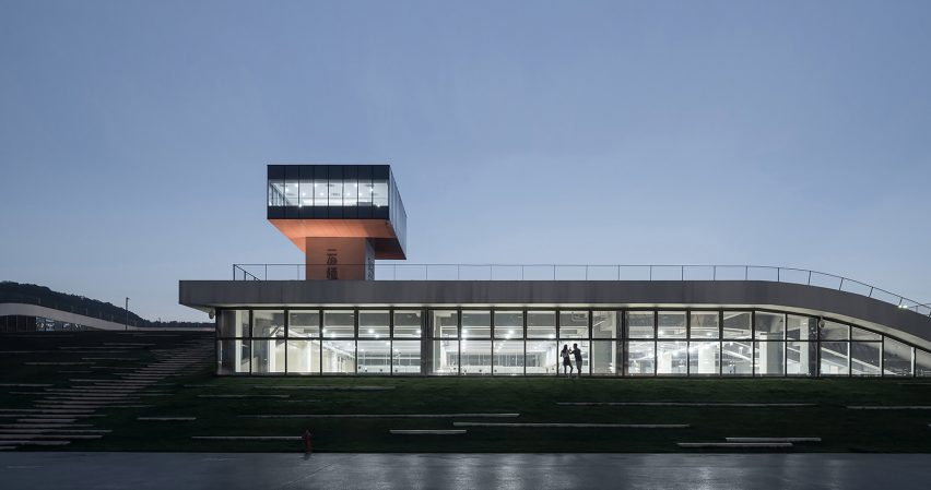Hangzhou Cloud Town Exhibition Center by Approach Design has a green roof with a running track