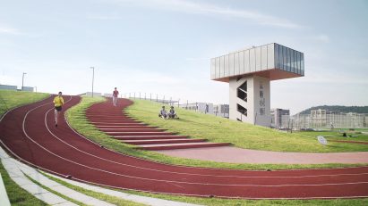 Hangzhou Cloud Town Exhibition Center by Approach Design has a green roof with a running track