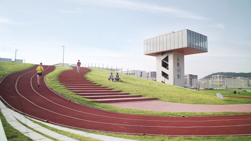 Hangzhou Cloud Town Exhibition Center by Approach Design has a green roof with a running track
