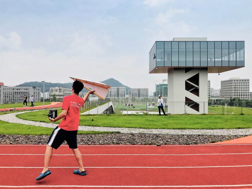 Hangzhou Cloud Town Exhibition Center by Approach Design has a green roof with a running track