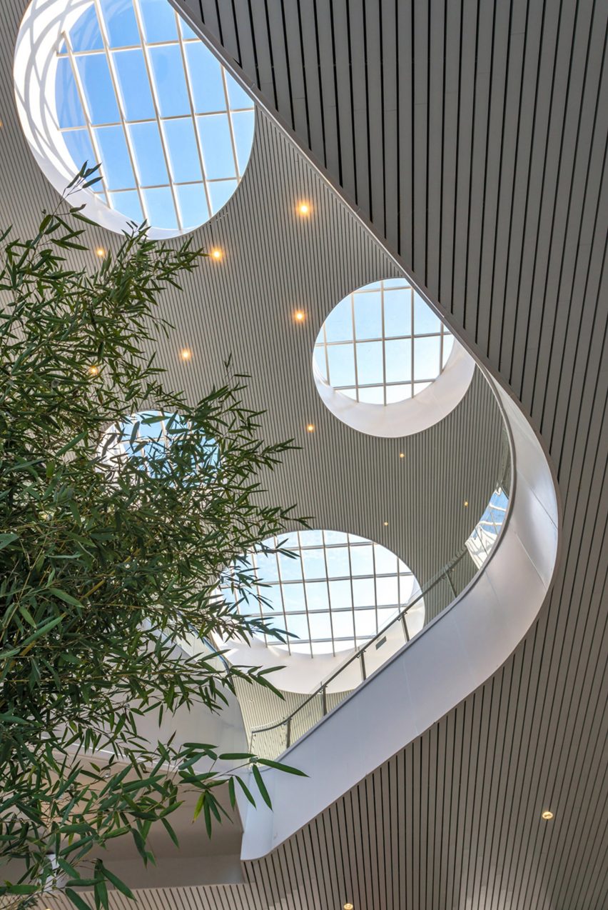 Hangzhou Cloud Town Exhibition Center by Approach Design has a green roof with a running track