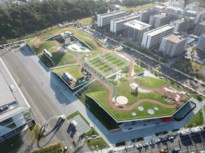 Hangzhou Cloud Town Exhibition Center by Approach Design has a green roof with a running track