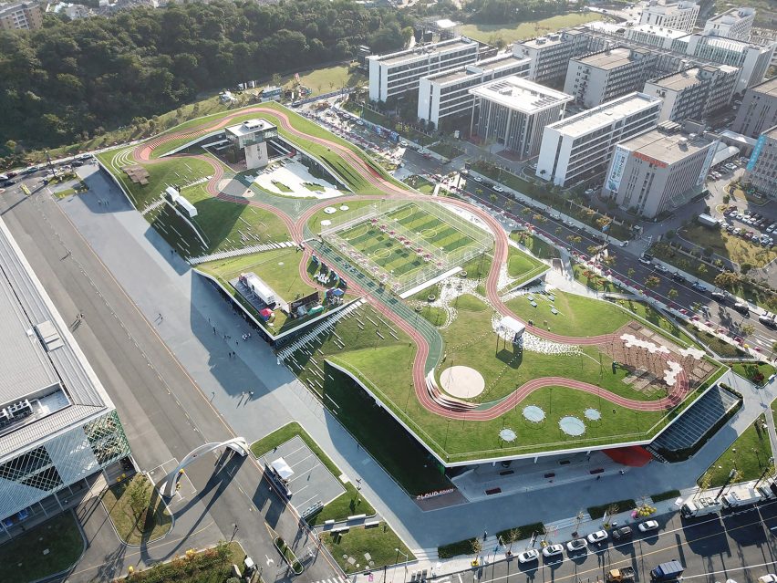 Hangzhou Cloud Town Exhibition Center by Approach Design has a green roof with a running track