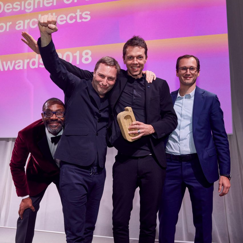 Jaspar Jansen and Jeroen Dellensen picking up their trophy for interior designer of the year at the Dezeen Awards 2018 ceremony
