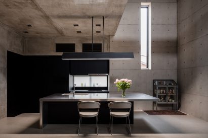 Bare concrete dining room in Tranquil House by FORM Kouichi Kimura Architects