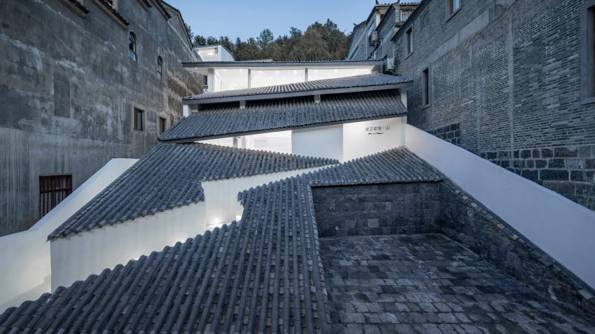 Studio QI cuts zigzagging entrance into sloped tiled roof of Annso Hill Hotel