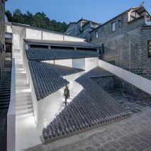 Studio QI cuts zigzagging entrance into sloped tiled roof of Annso Hill Hotel