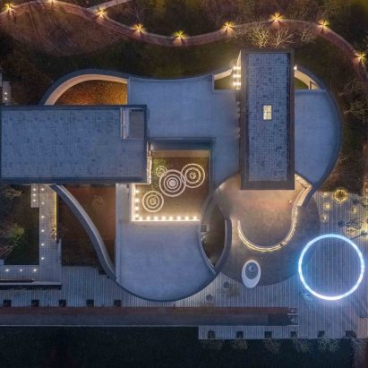 Curving stone walls surround the Hefei River Central Smart Garden Library in China