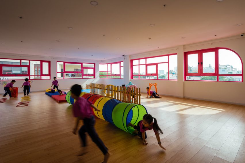 TTC Elite Saigon Kindergarten in by Kientruc O in has a distinctive facade decorated with colourful patches and irregularly shaped windows.